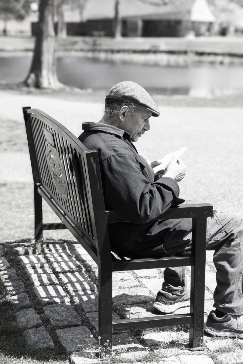 A photograph of a man sitting on a bench featured in Cristo's exhibit.