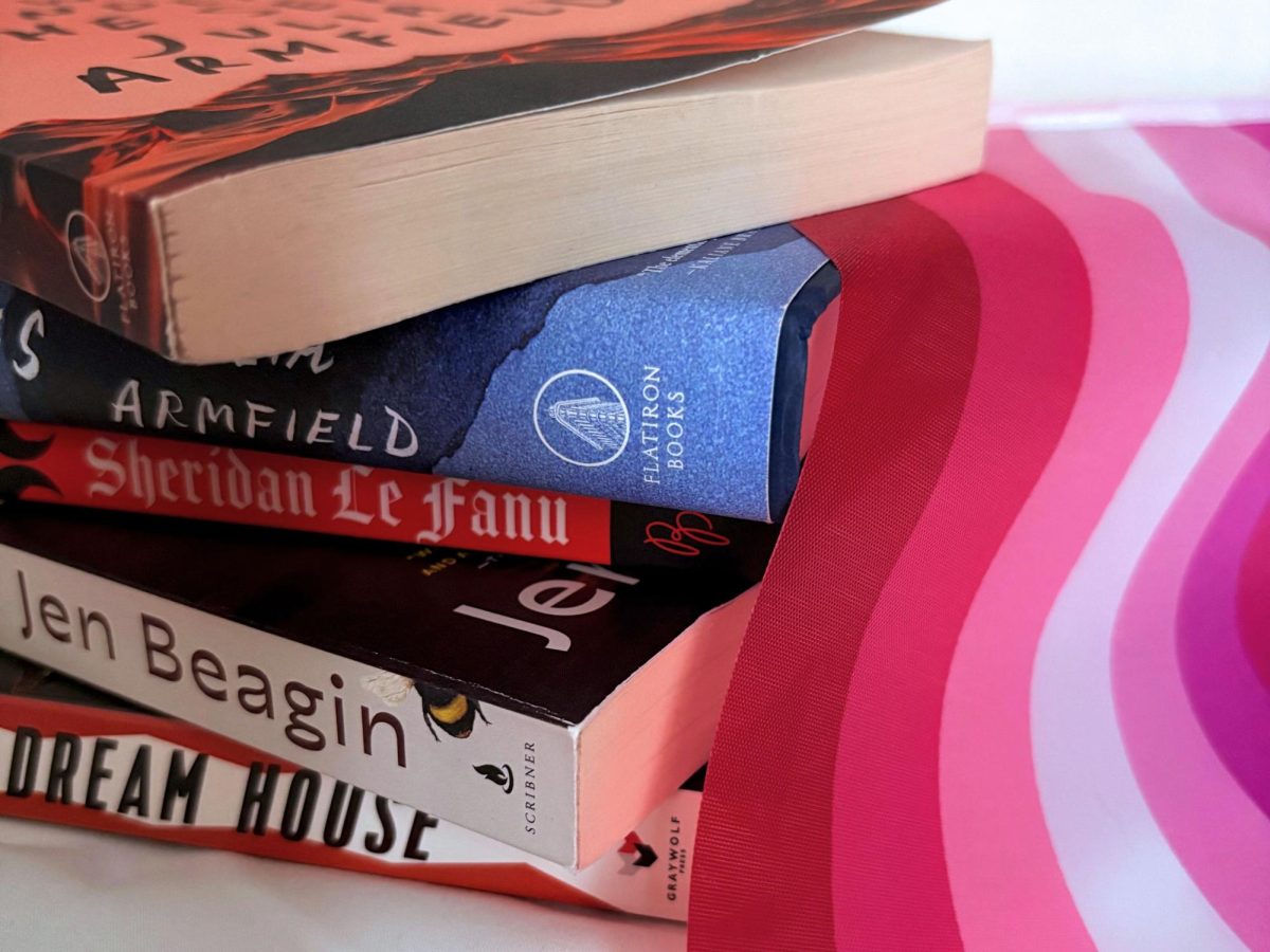 A stack of books with a lesbian pride flag.

